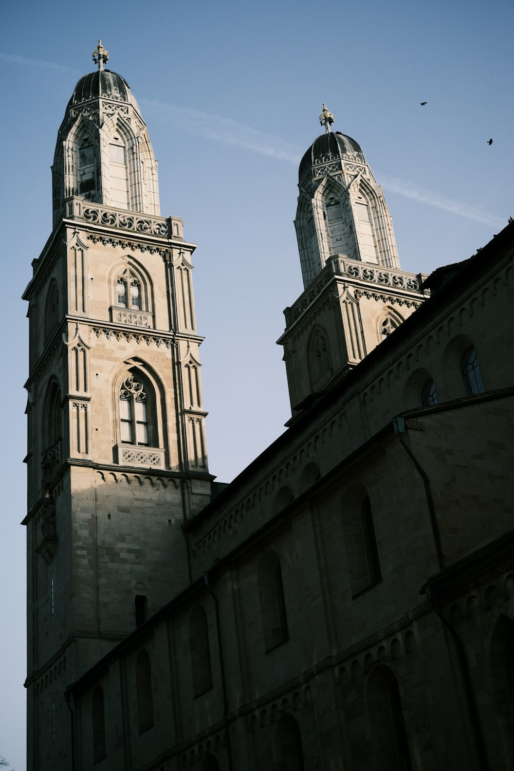 two towers of a building with a sky background