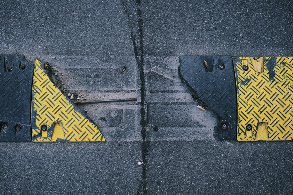 a couple of yellow and black street signs on a road