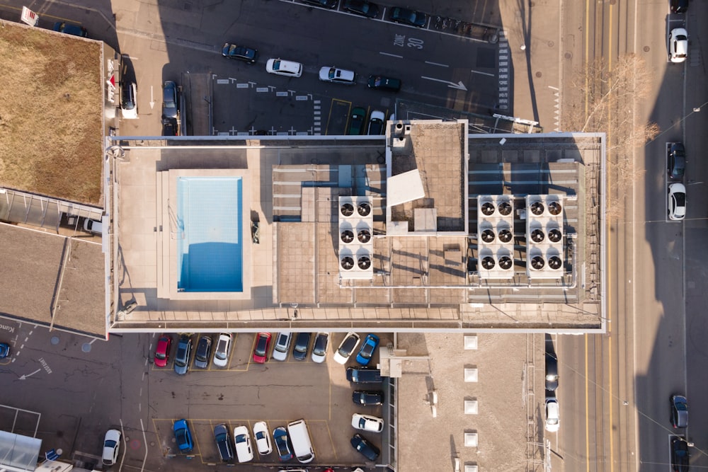 an aerial view of a parking lot with a swimming pool