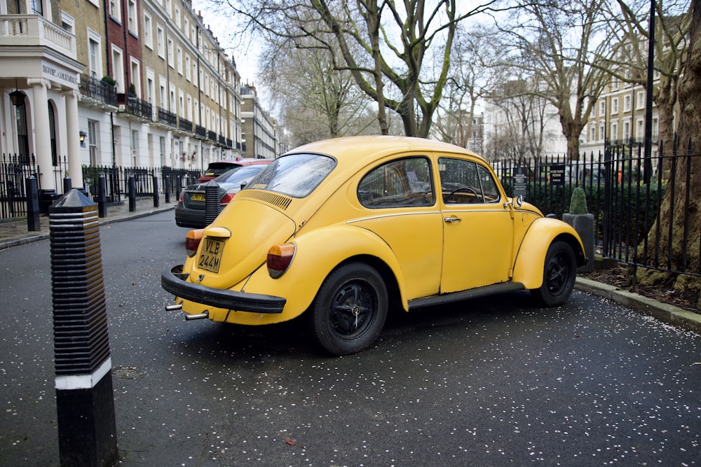 a yellow car parked on the side of the road