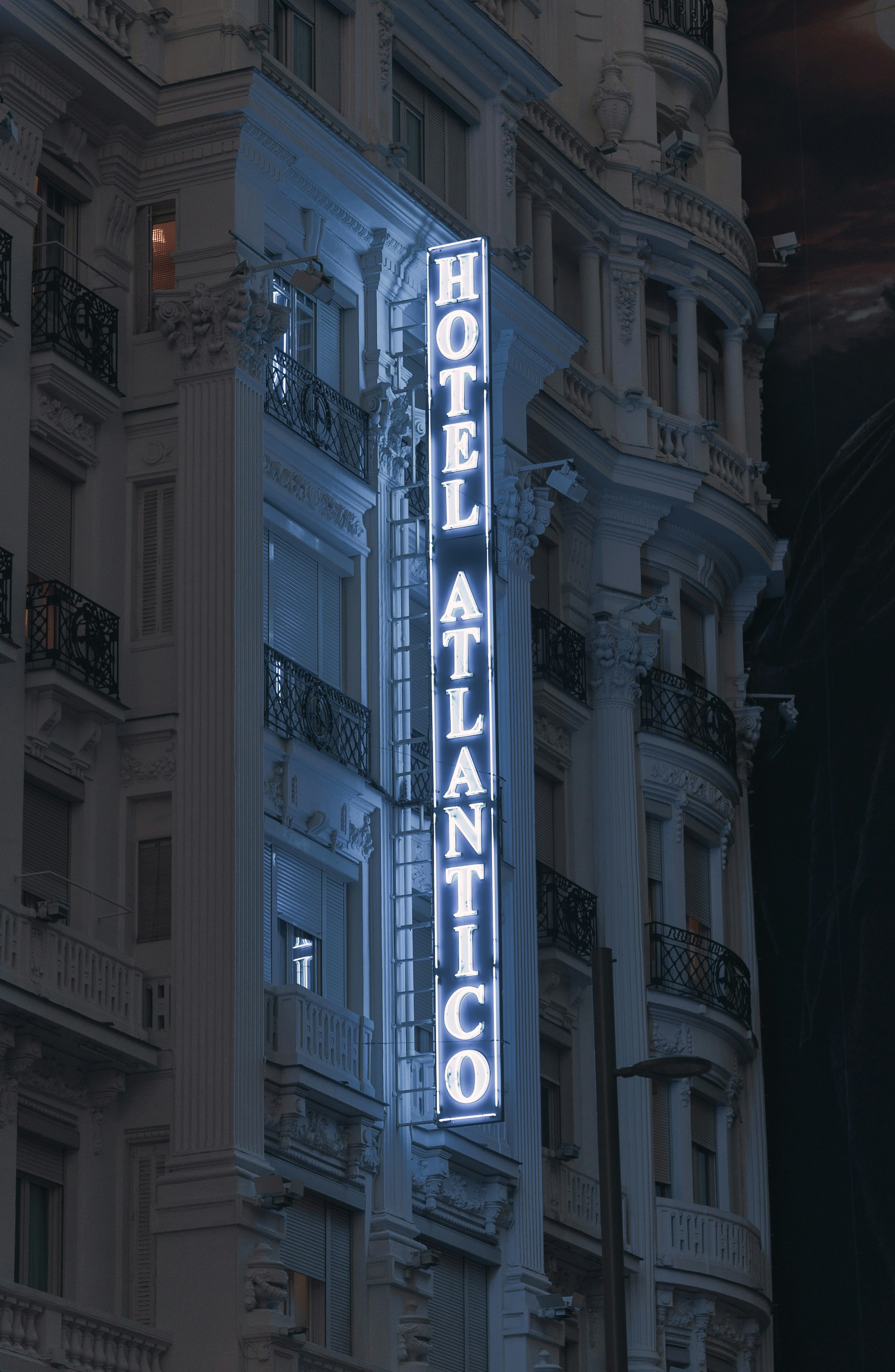 a building with a neon sign on the side of it