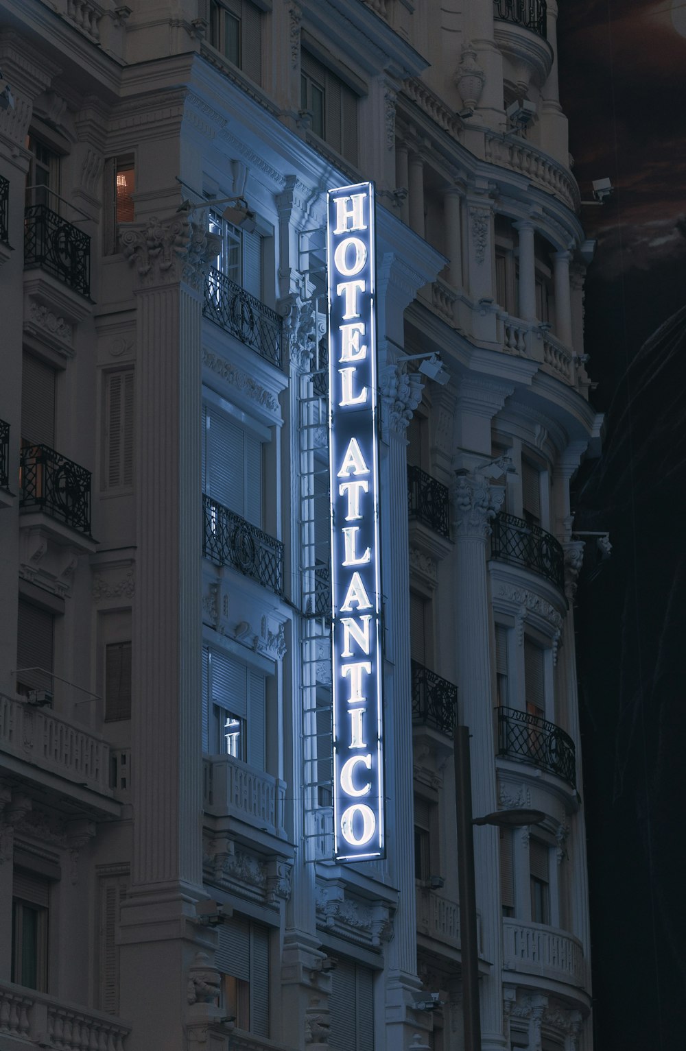 a building with a neon sign on the side of it