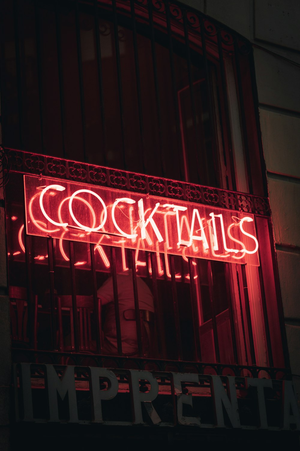 a neon sign that reads cocktails on the side of a building