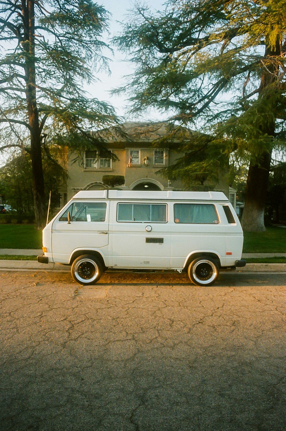 a white van parked in front of a house