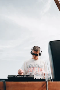 a man wearing headphones and a white shirt