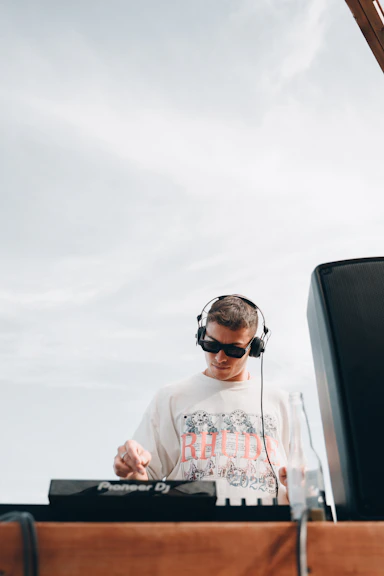 a man wearing headphones and a white shirt