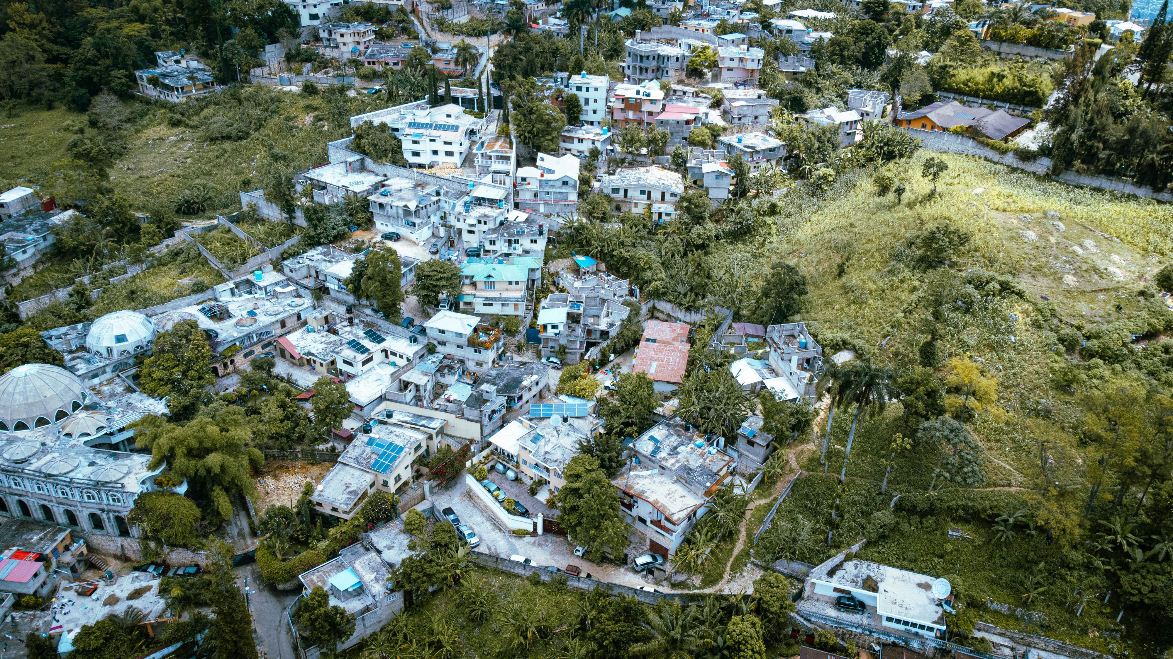Aerial view of a city with trees, representing project locations