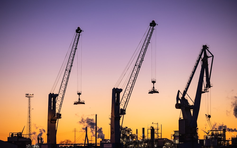 a group of cranes that are sitting in the sky