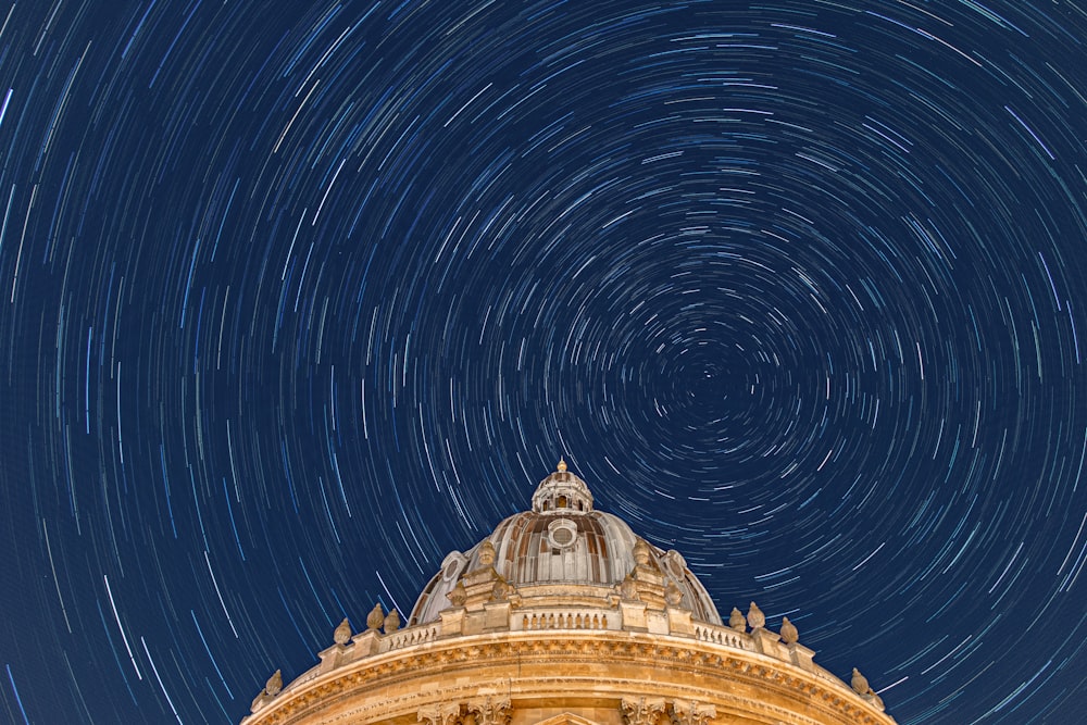 a building with a star trail in the sky above it