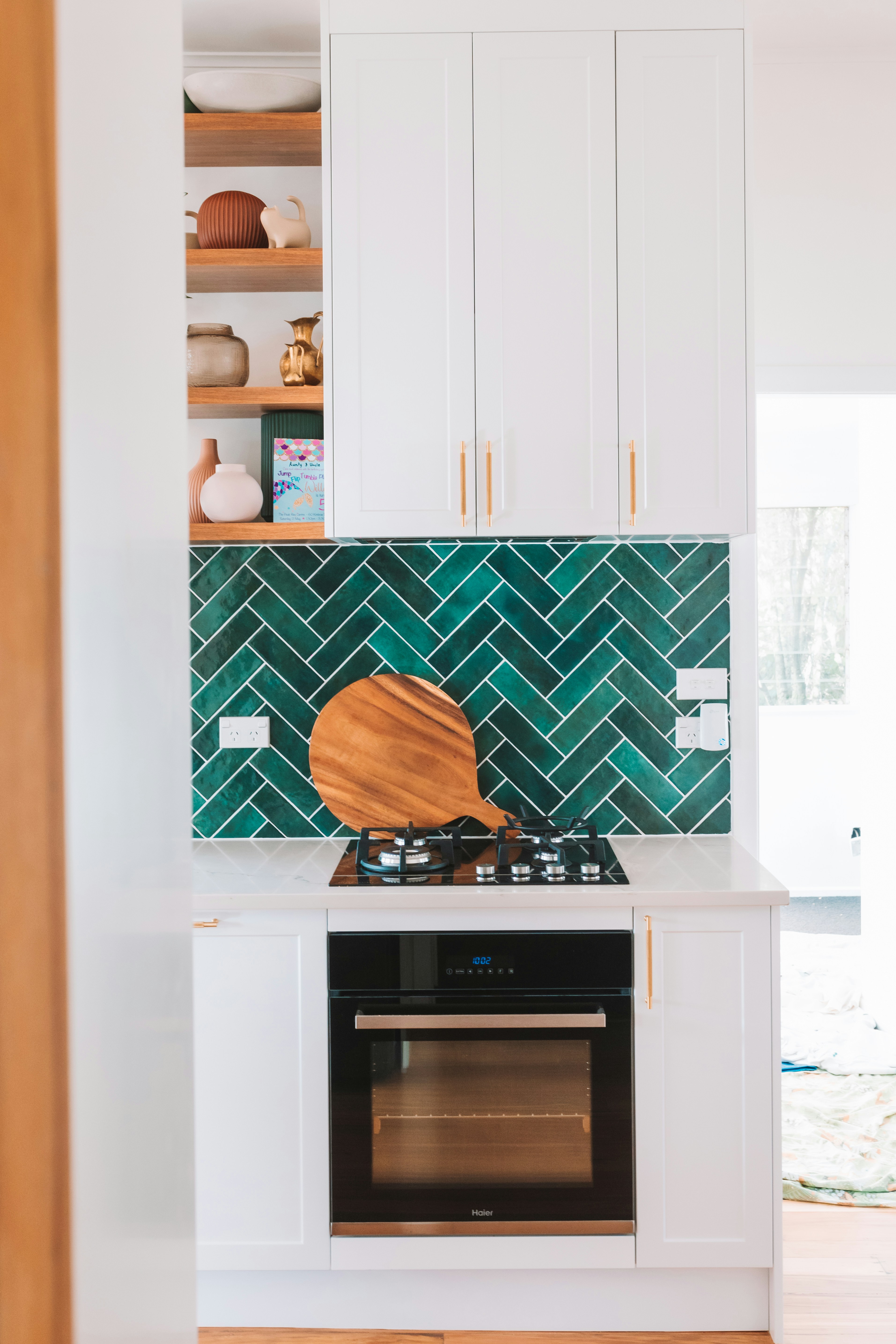 a stove top oven sitting inside of a kitchen