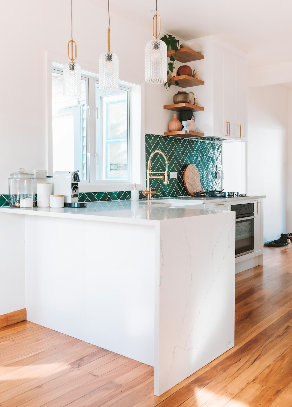 a kitchen with a marble island and wooden floors