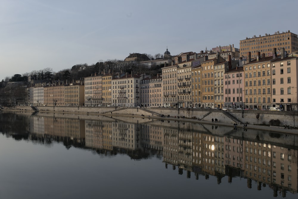 a river running through a city next to tall buildings