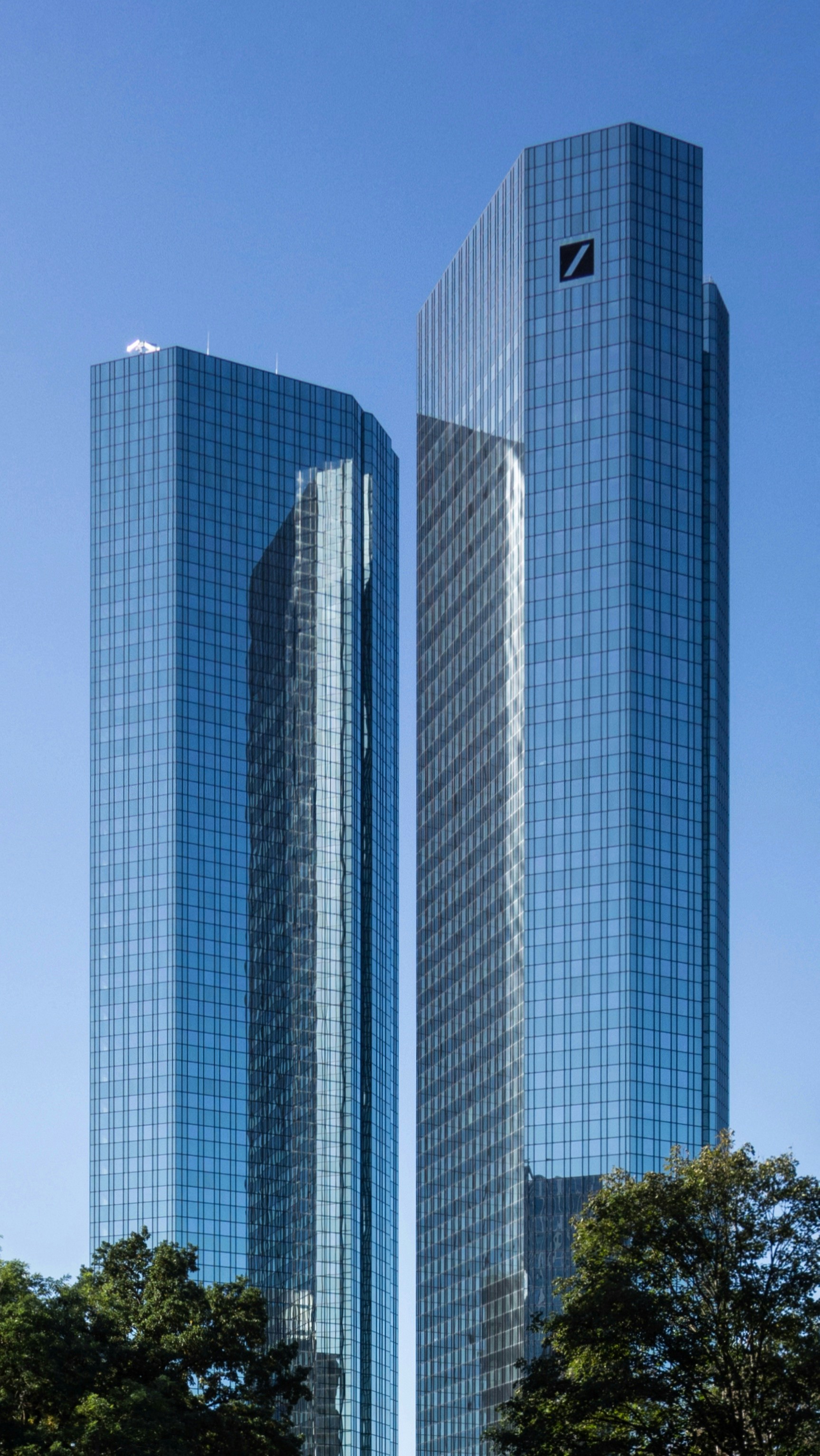 two very tall buildings in a city park