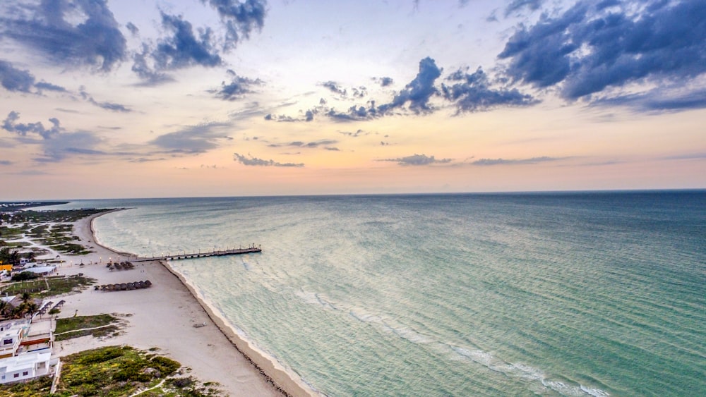 an aerial view of a beach and a pier