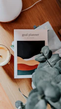 a table with a plant and a candle on it