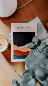 a table with a plant and a candle on it