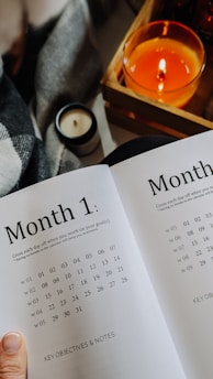 A calendar marked with a full month of marketing activities in a cozy workspace.
