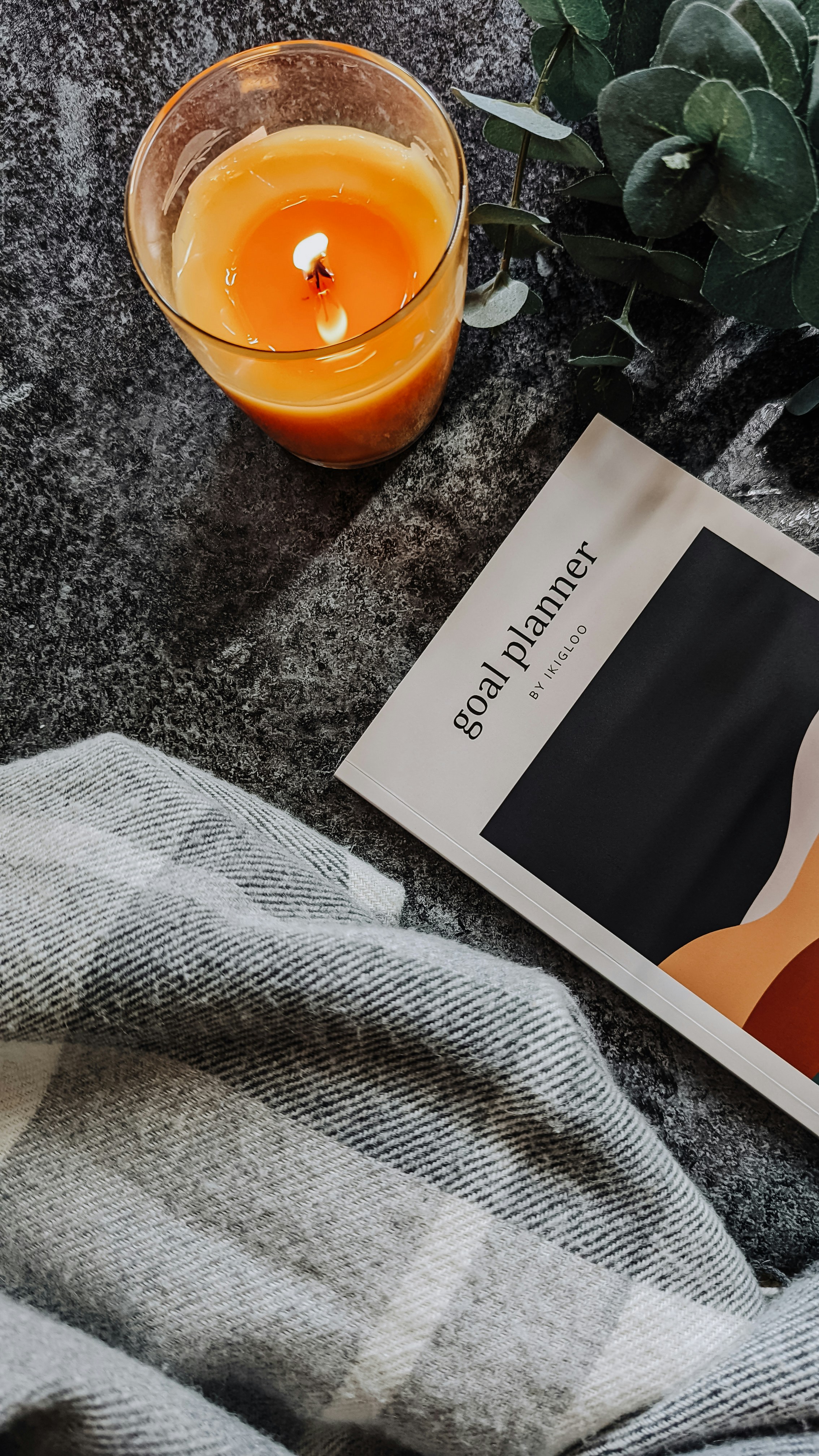 a book sitting on top of a table next to a glass of orange juice