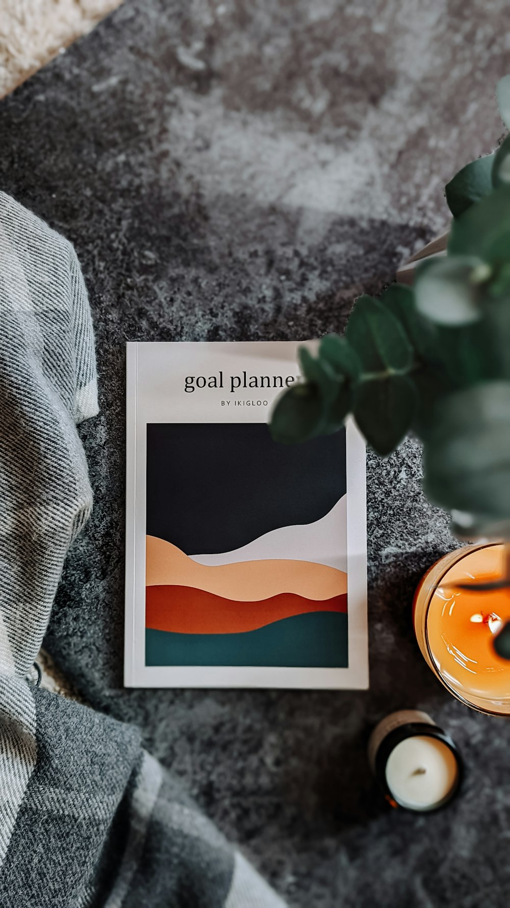 a book sitting on top of a table next to a candle