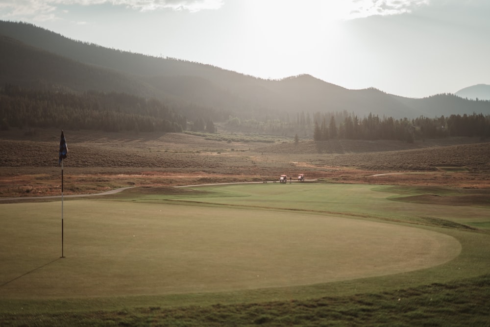 a view of a golf course in the mountains