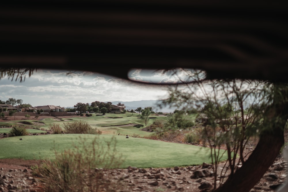 a view of a golf course through a hole
