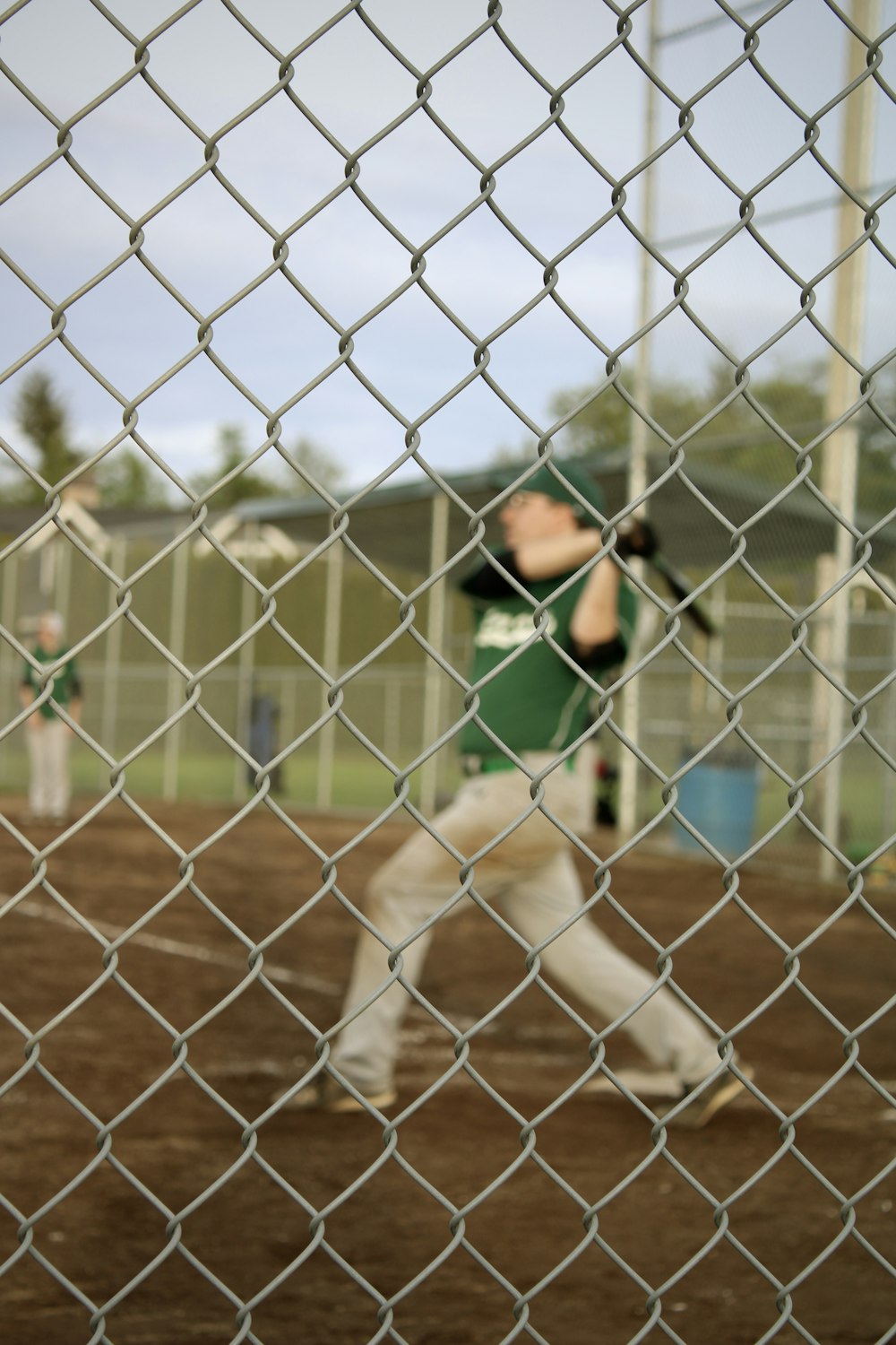 a baseball player swinging a bat at a ball