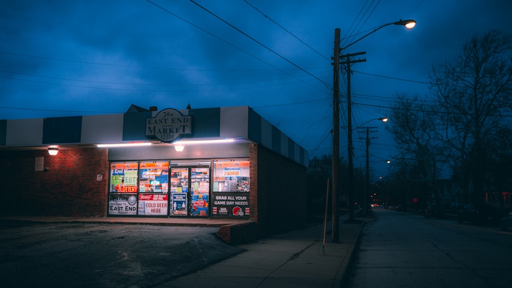 a dark street with a store front at night