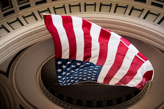 a large american flag flying in the air