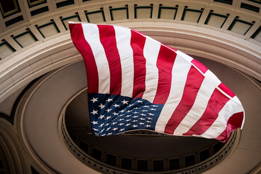 a large american flag flying in the air