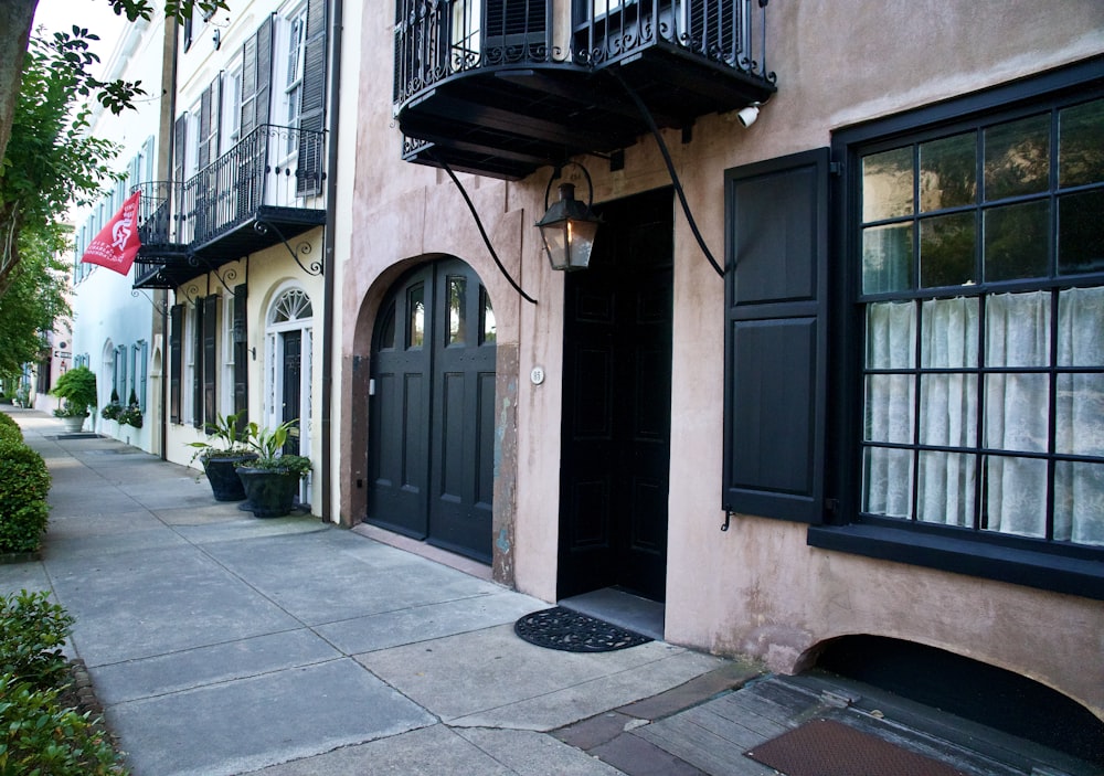 a building with black shutters and a black door