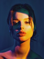 A color portrait featuring vibrant reds and deep shadows, capturing raw cinematic realism.