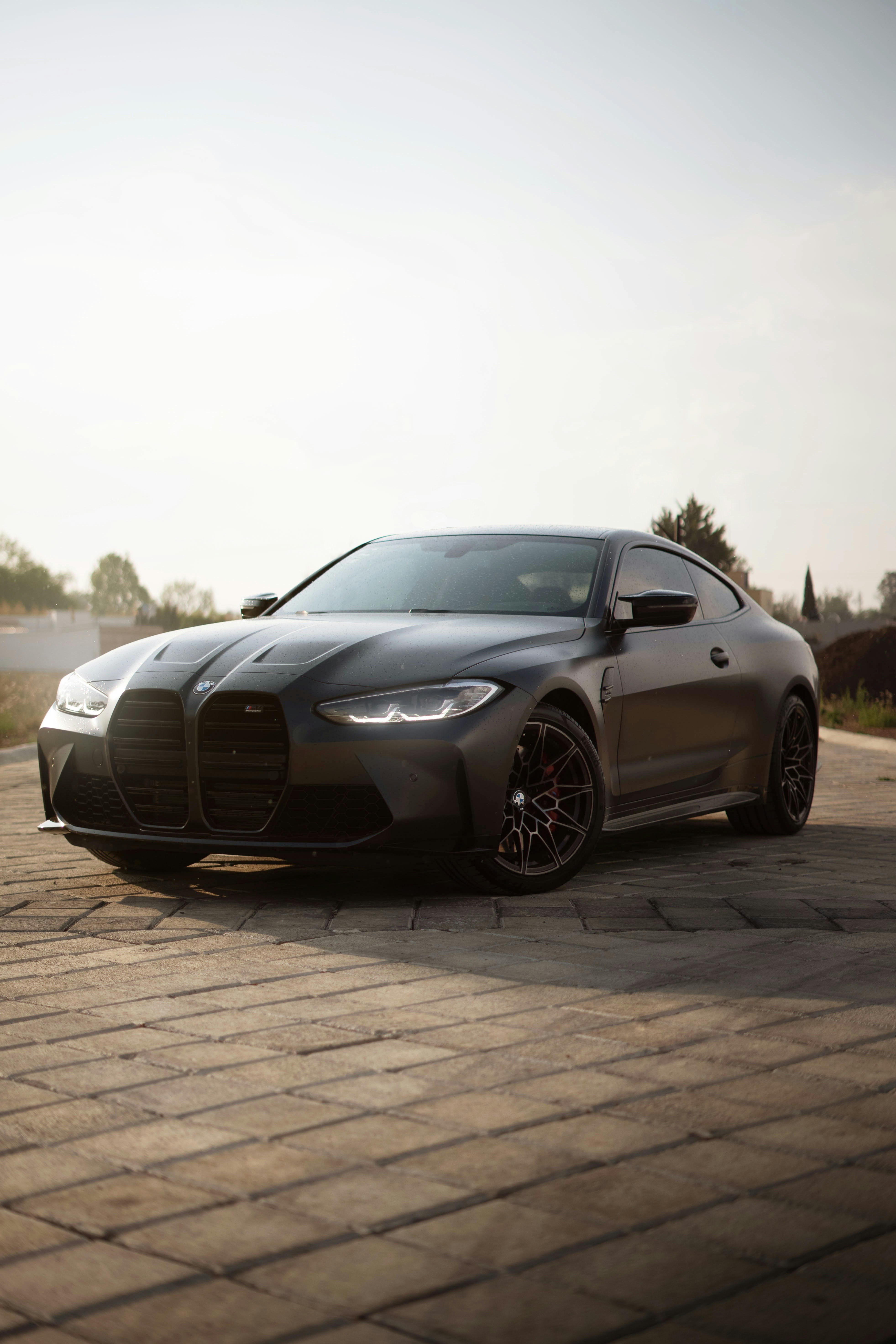 a black sports car parked on a brick road