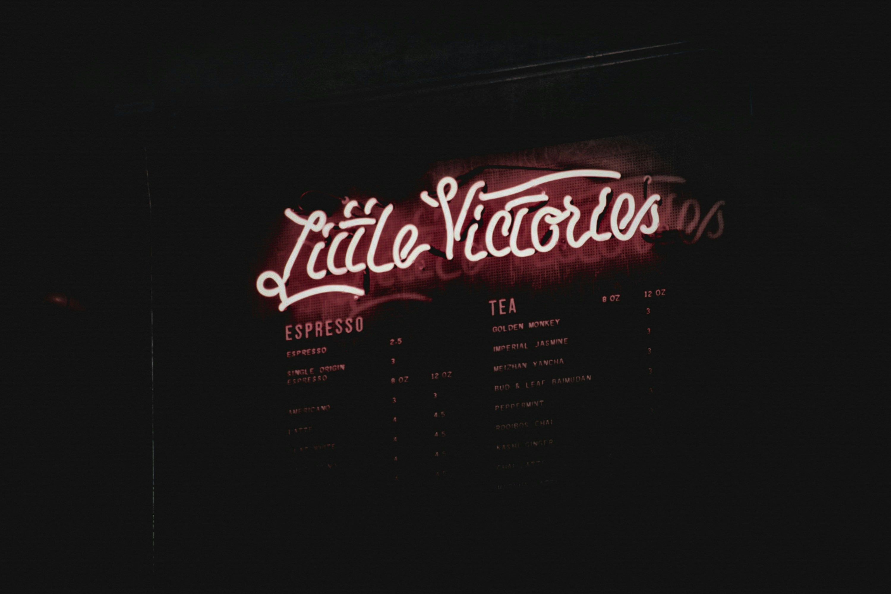 a neon sign is lit up in the dark