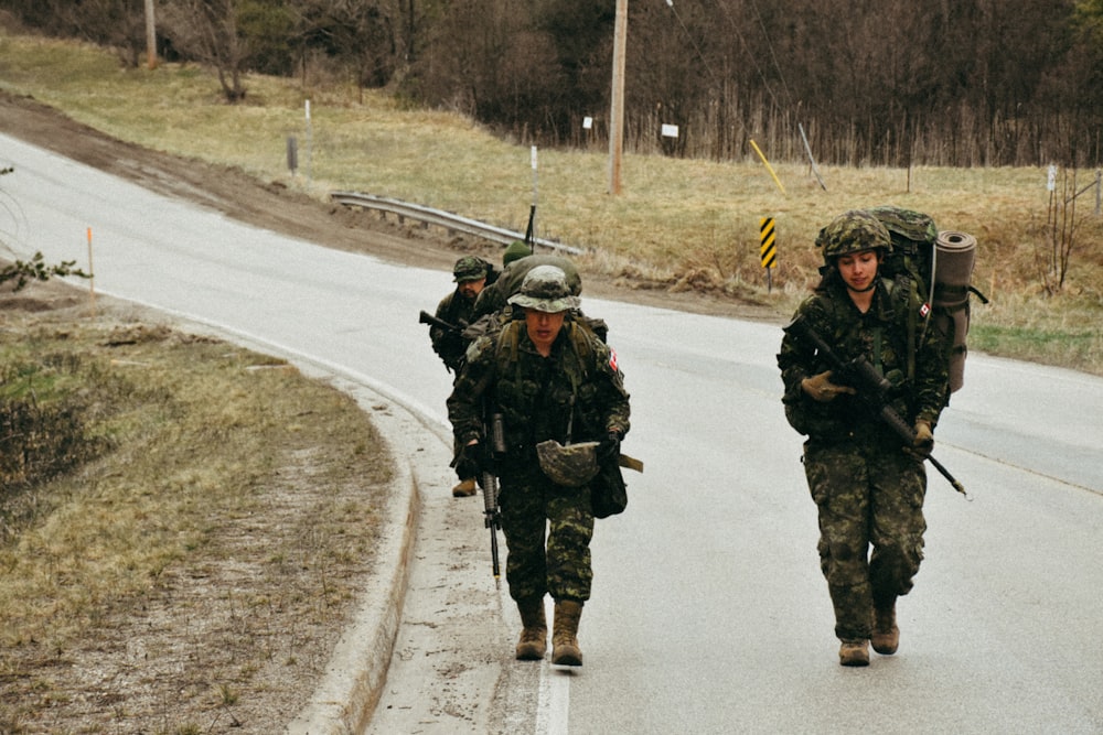 a group of soldiers walking down a road