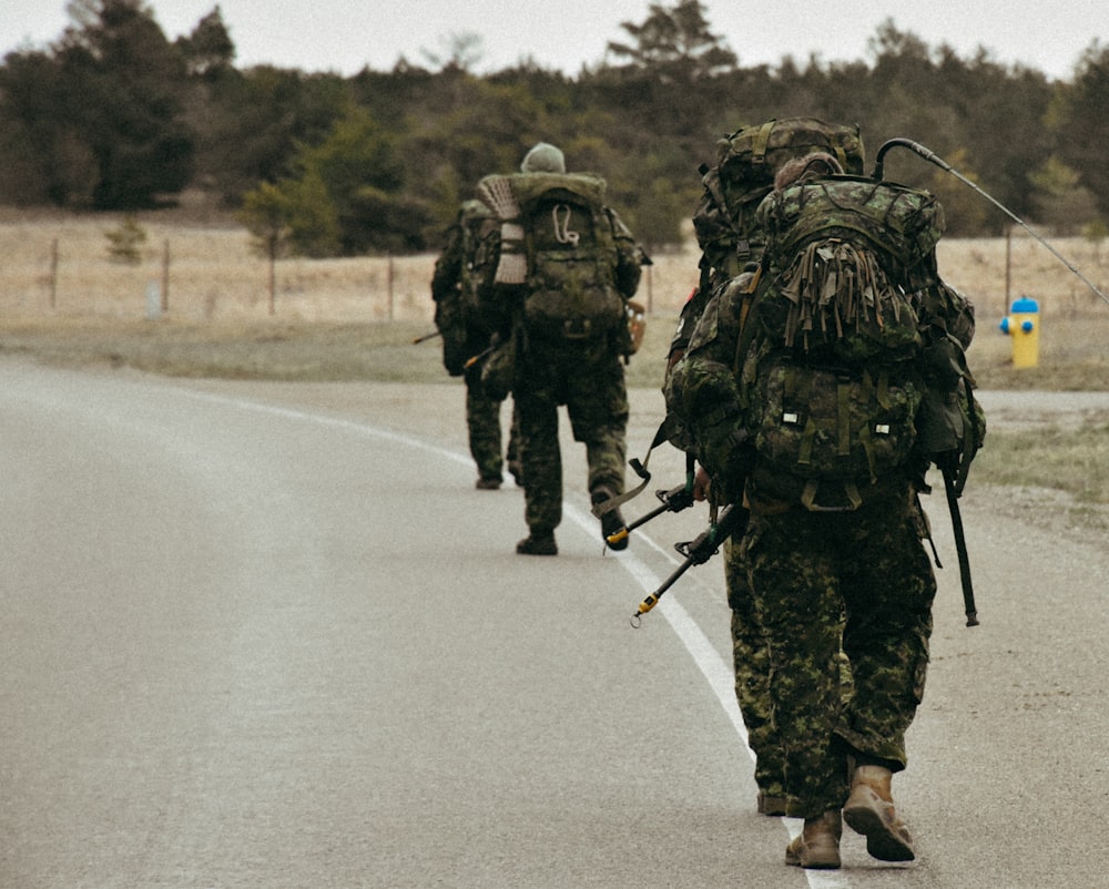 a group of soldiers walking down a road
