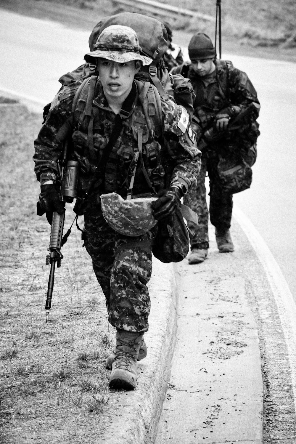 a group of soldiers walking down a road
