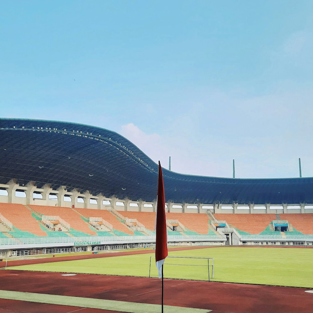 an empty stadium with a flag in the foreground