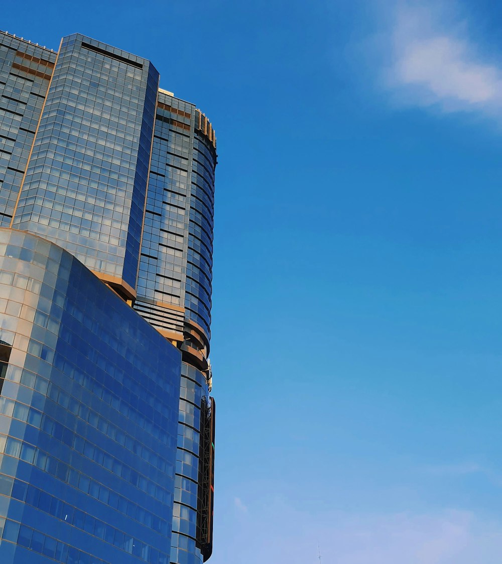 a plane flying in the air near a tall building