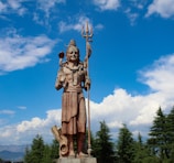 a statue of a person holding a staff