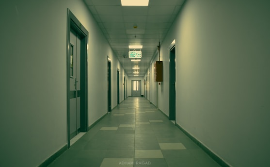 a long hallway with a sign hanging from the ceiling