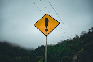 a yellow sign with a black symbol on it