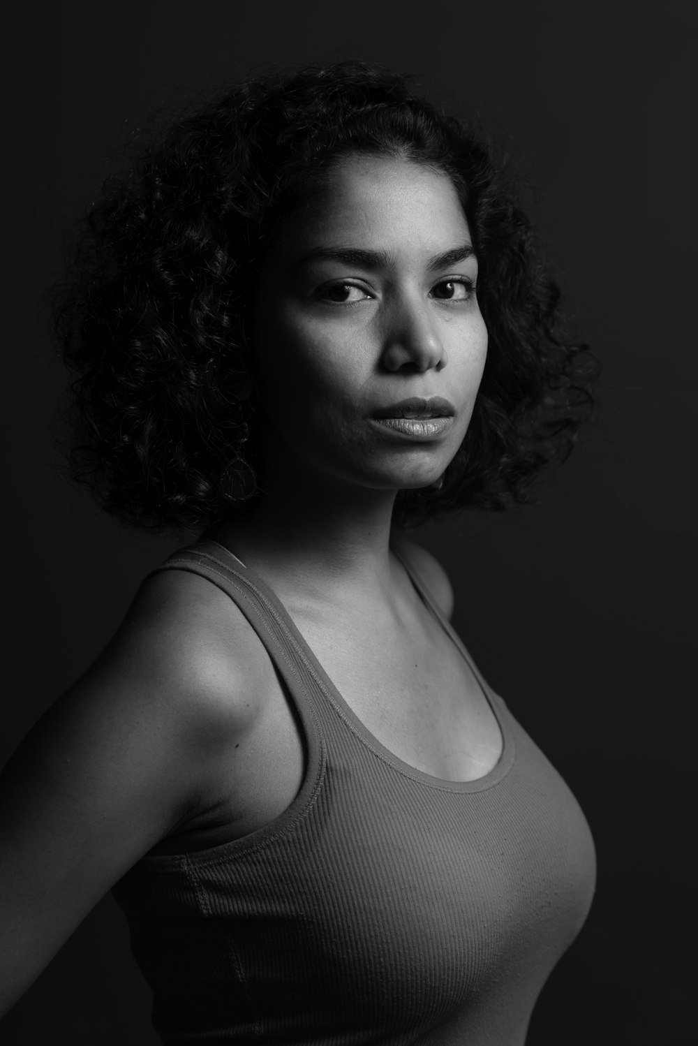 a black and white photo of a woman with curly hair