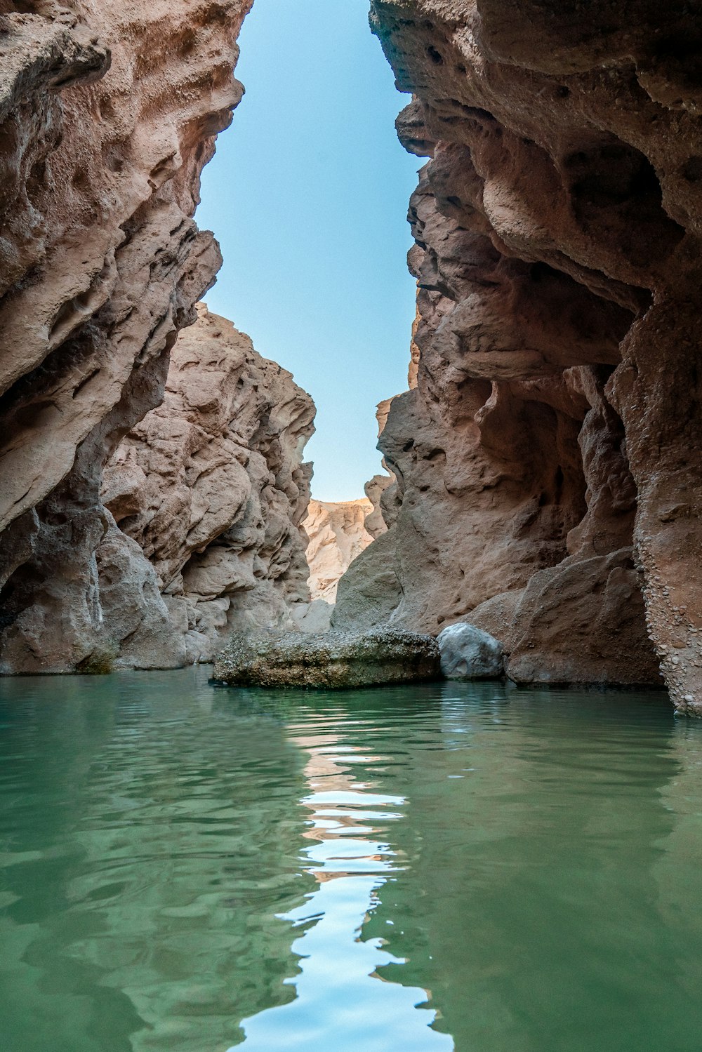 a body of water surrounded by large rocks