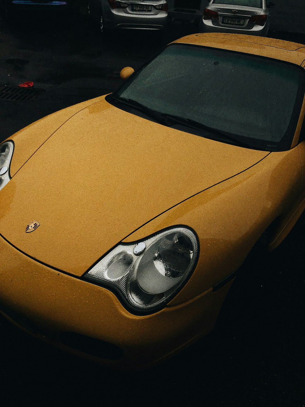 a yellow sports car parked in a parking lot