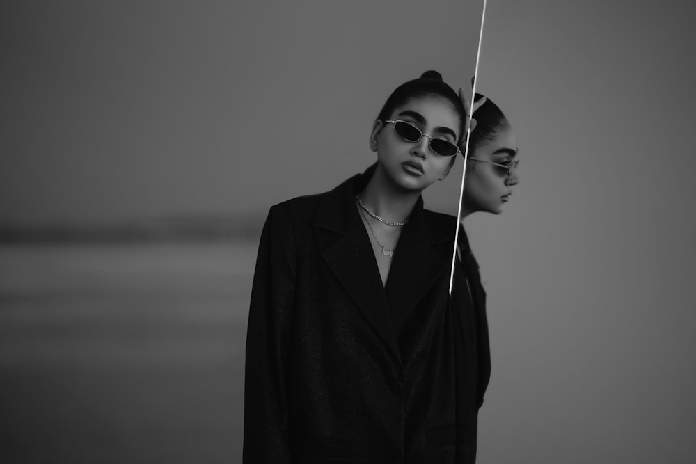 two women wearing sunglasses standing next to each other