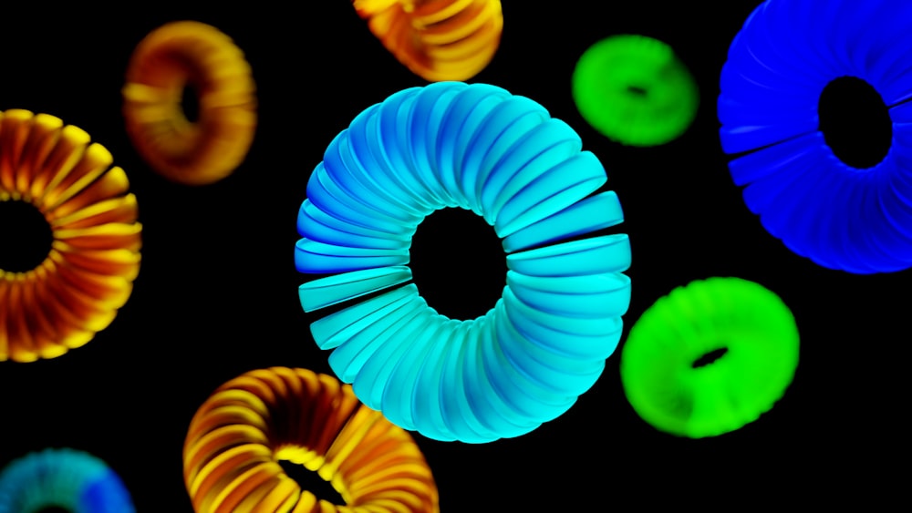 a group of different colored rings on a black background