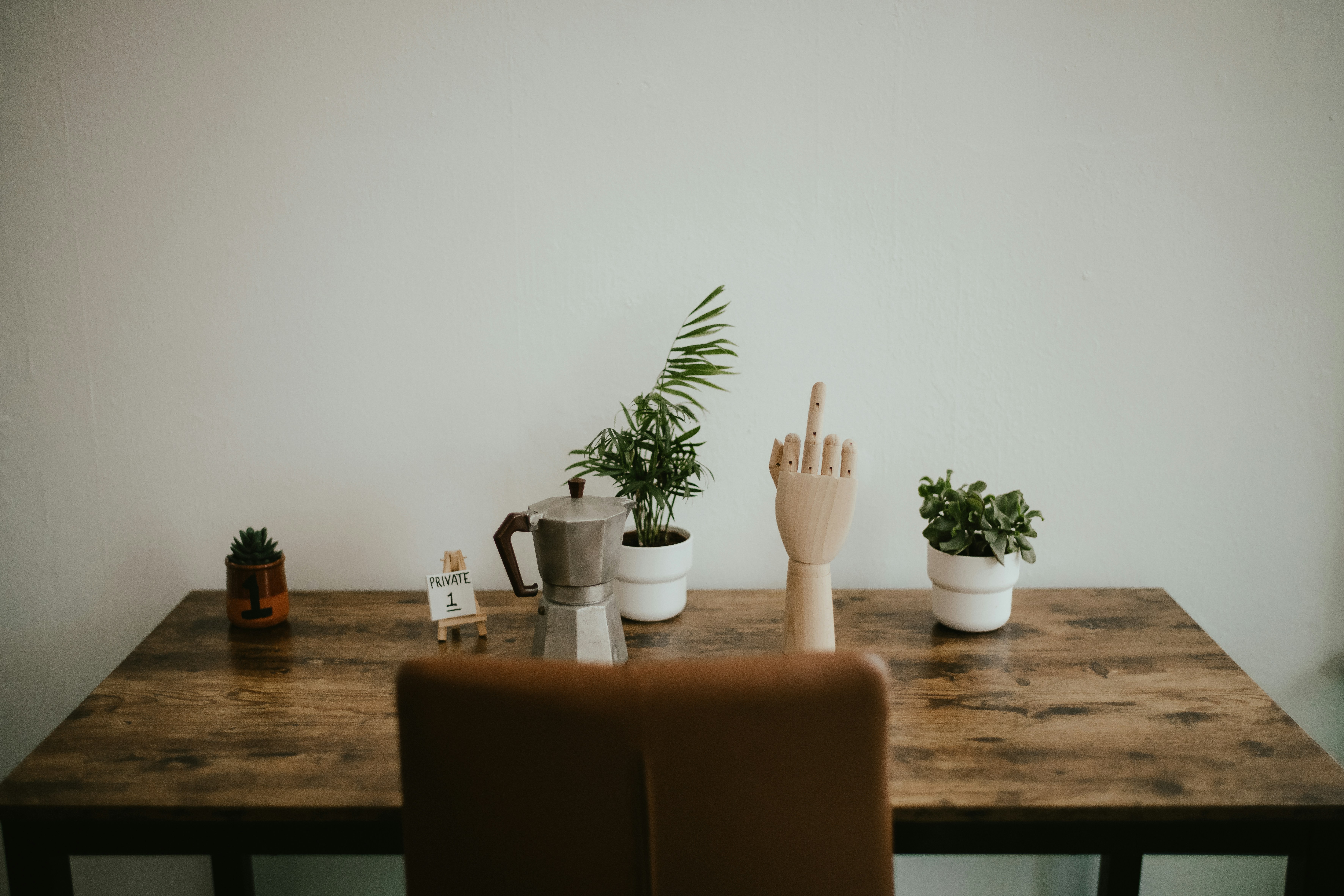 a vase of flowers sitting on top of a wooden table