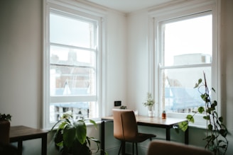 A calm office corner with bamboo decor, soft shadows, and a warm beige wall.