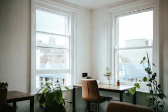 A serene studio corner with plants and natural light, reflecting a calm and eco-friendly atmosphere.