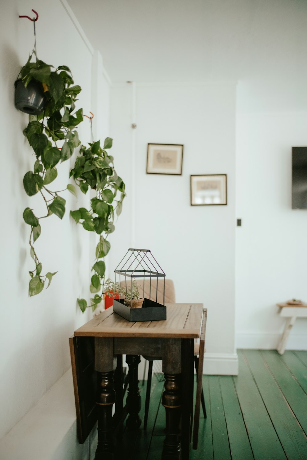 a room filled with furniture and vase of flowers on a table